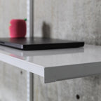 Close-up of steel shelf front edge showing folded lip and powder-coated finish